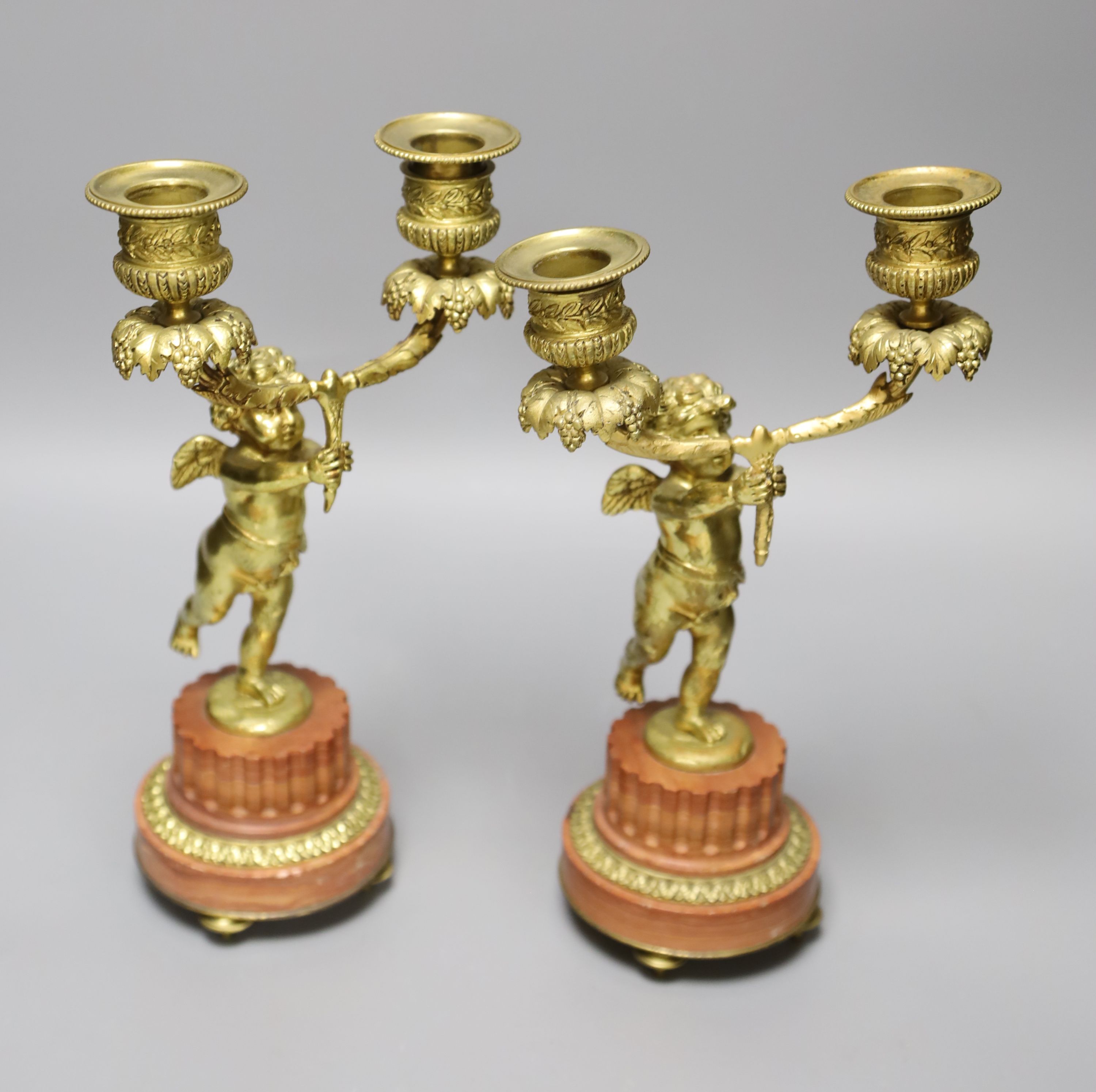 A pair of French ormolu cherub two branch candelabra, height 27.5cm